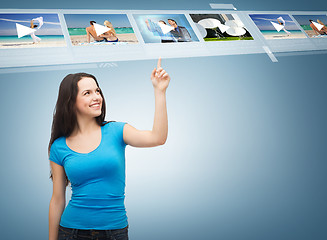 Image showing smiling teenager pointing her finger videos