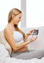 Image showing happy pregnant woman with ultrasound picture