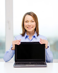 Image showing businesswoman with blank black laptop screen