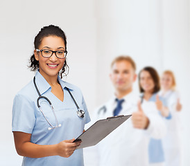 Image showing smiling female african american doctor or nurse