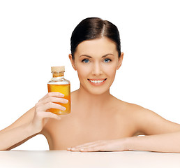 Image showing beautiful woman with oil bottle