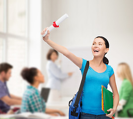 Image showing smiling student with bag and folders