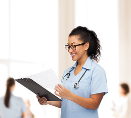 Image showing smiling female african american doctor or nurse