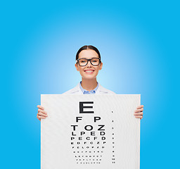 Image showing female doctor in eyeglasses with eue chart