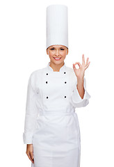 Image showing smiling female chef showing ok hand sign