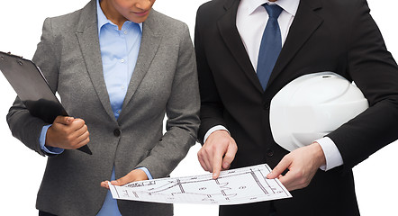 Image showing businesspeople with blueprint and helmet