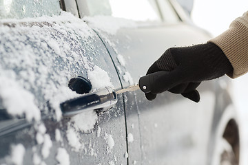 Image showing closeup of man hand opening car with key