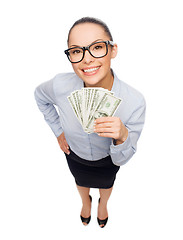 Image showing smiling businesswoman with dollar cash money