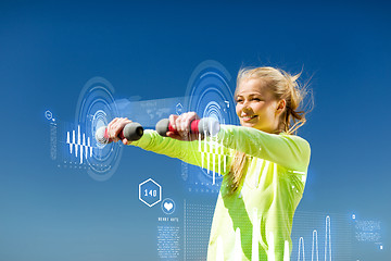 Image showing sporty woman with light dumbbells outdoors