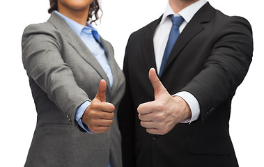 Image showing businessman and businesswoman showing thumbs up