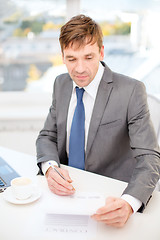 Image showing businessman with laptop computer and documents