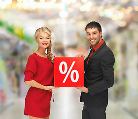 Image showing smiling man and woman with percent sign