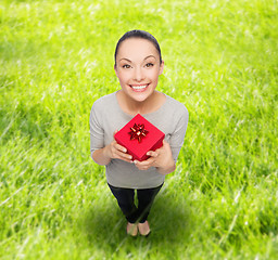 Image showing smiling asian woman with red gift box