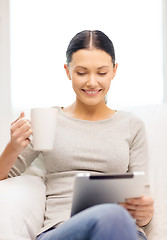 Image showing smiling woman with tablet pc computer and cup
