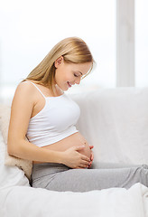 Image showing happy pregnant woman touching her belly