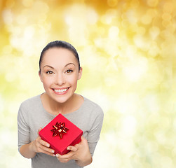 Image showing smiling asian woman with red gift box