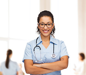 Image showing smiling female african american doctor or nurse