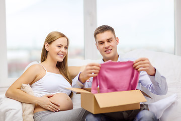 Image showing happy family expecting child opening parcel box