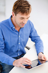 Image showing man working with tablet pc at home