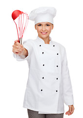 Image showing smiling female chef with cooking equipment