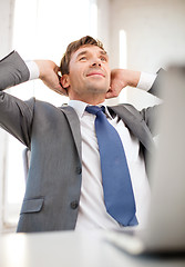 Image showing relaxed businessman with laptop in office