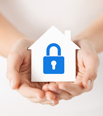 Image showing hands holding paper house with lock