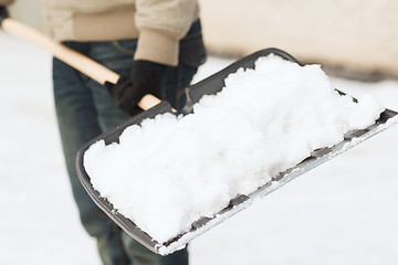 Image showing closeup of man shoveling snow from driveway