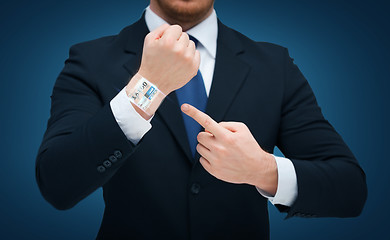 Image showing businessman pointing to something at his hand