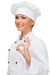 Image showing smiling female chef showing ok hand sign