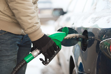 Image showing close up of male refilling car fuel tank