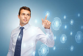 Image showing businessman working with imaginary virtual screen