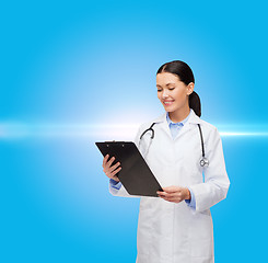 Image showing smiling female doctor with clipboard