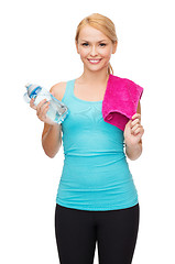 Image showing sporty woman with towel and watel bottle