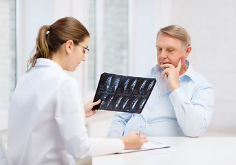 Image showing female doctor with old man looking at x-ray