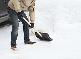 Image showing closeup of man shoveling snow from driveway