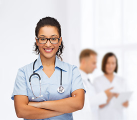 Image showing smiling female african american doctor or nurse