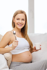 Image showing happy pregnant woman with yogurt