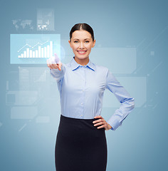 Image showing smiling businesswoman pointing finger to button