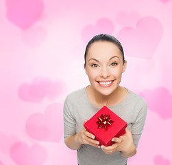 Image showing smiling asian woman with red gift box