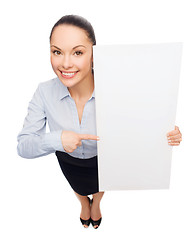 Image showing businesswoman pointing to white blank board