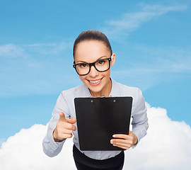 Image showing smiling businesswoman in eyeglasses with clipboard
