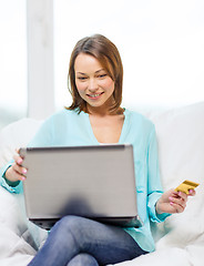 Image showing smiling woman with laptop computer at home