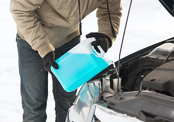 Image showing closeup of man pouring antifreeze into water tank