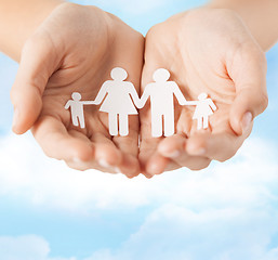 Image showing female hands with paper man family