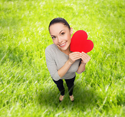 Image showing smiling asian woman with red heart