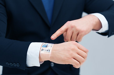 Image showing businessman pointing to something at his hand