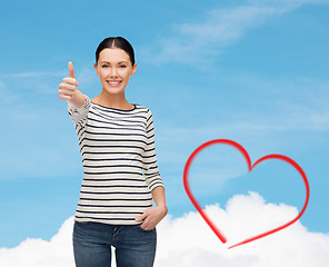 Image showing smiling girl in casual clother showing thumbs up