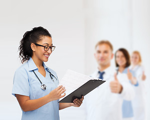 Image showing smiling female african american doctor or nurse