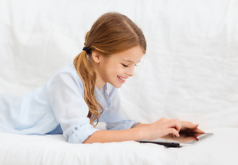 Image showing smiling girl with tablet computer at home