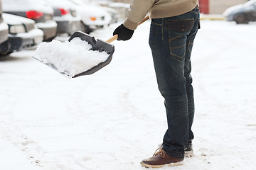 Image showing closeup of man shoveling snow from driveway
